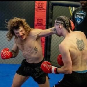 Belleville boxer in intense match, ready to land a devastating left hook on his opponent, displaying power and skill during a competitive fight