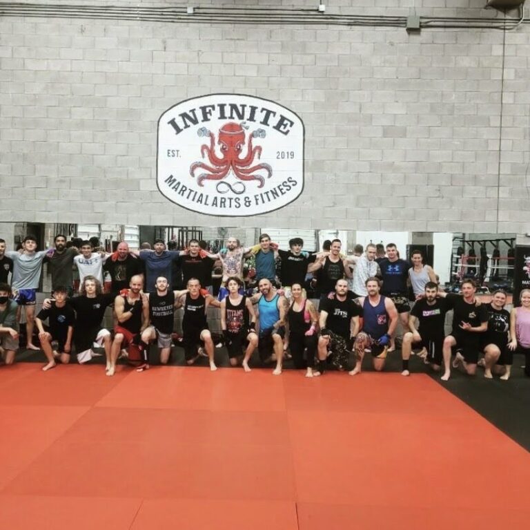 Boxing gym training group in Belleville, Ontario, engaged in intense workout session, including punching, technical training, and fitness conditioning.